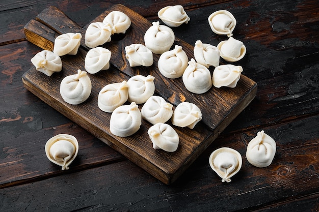 Frozen tortellini set on cutting board on old dark  wooden table background