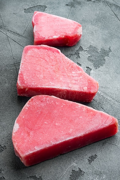 Frozen tuna fish steaks set, on gray stone