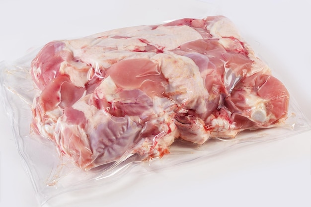 Frozen turkey or poultry meat in vacuum packaging on a white background