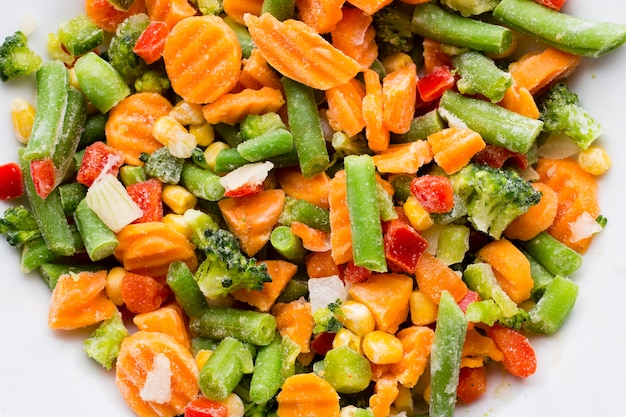 Frozen vegetables  in a white plate.