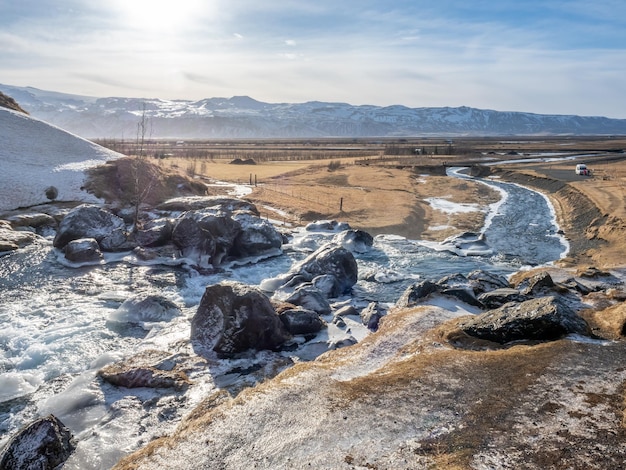 Frozen water in river under Gluggafoss waterfall in winter season Iceland