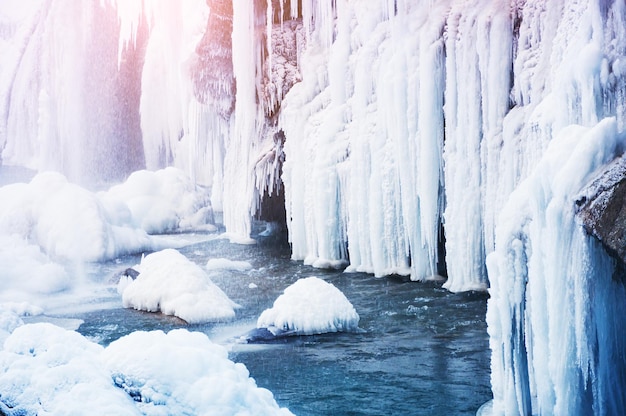 Frozen waterfall in the mountains. Beautiful winter landscape.