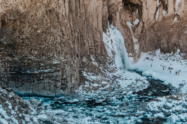 Frozen waterfall in winter in the mountains. Mountains landscape photo.