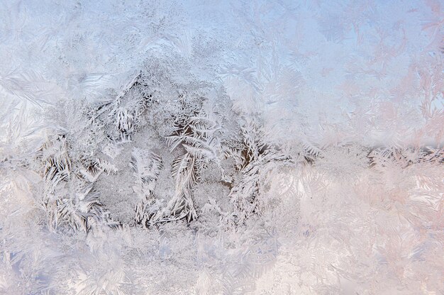 Frozen window glass in hoarfrost patterns on cold winter day