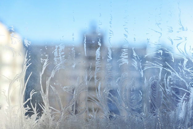 Frozen winter window with shiny ice frost pattern texture