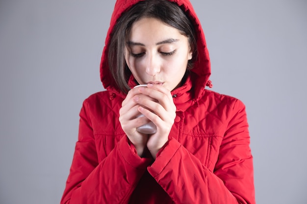 Frozen young woman hand cup of tea