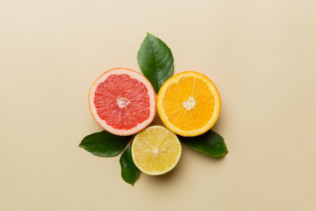 Fruit background Colorful fresh fruits on colored table Orange lemon grapefruit Space for text healthy concept Flat lay top view copy space