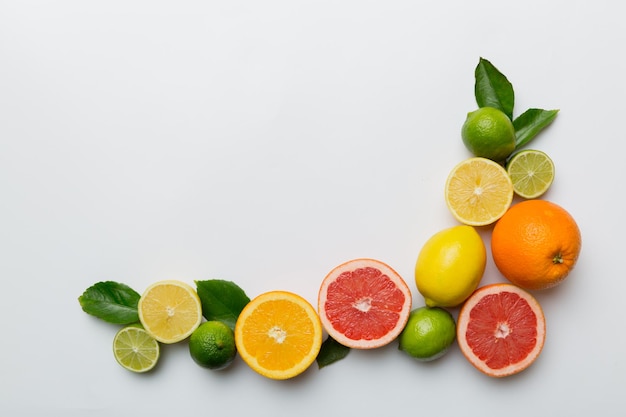 Fruit background Colorful fresh fruits on colored table Orange lemon grapefruit Space for text healthy concept Flat lay top view copy space