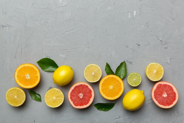 Fruit background Colorful fresh fruits on colored table Orange lemon grapefruit Space for text healthy concept Flat lay top view copy space