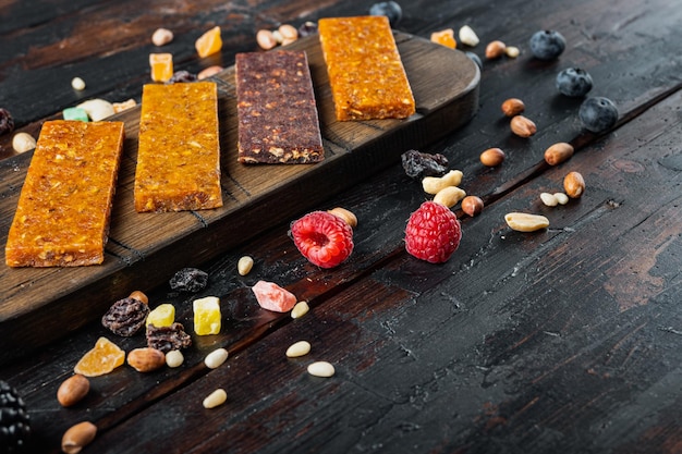 Fruit berry and nut energy bars, healthy snack with space for text, on wooden table