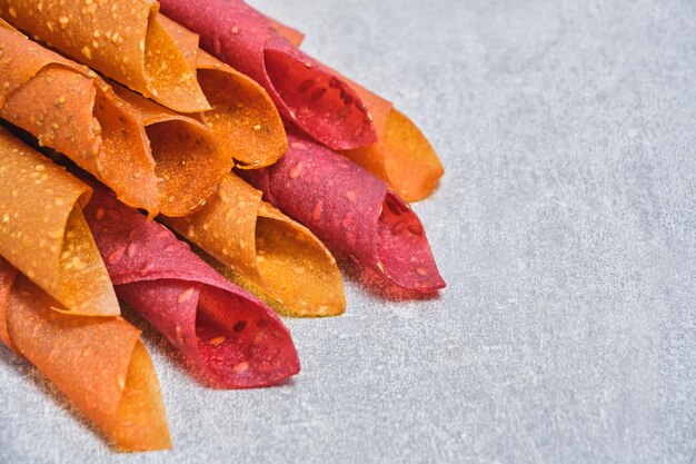 Fruit and berry pastille dessert with nuts and seeds on a light background