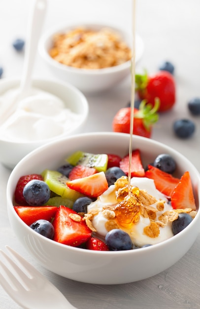 Fruit berry salad with yogurt and granola for healthy breakfast