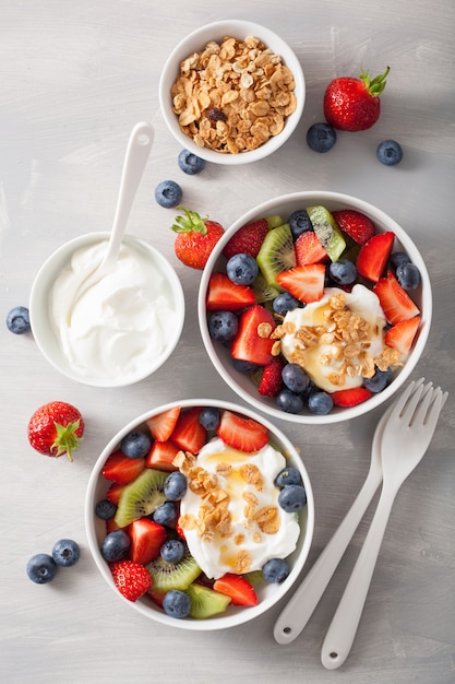 Fruit berry salad with yogurt and granola for healthy breakfast