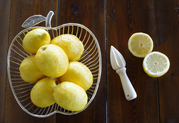 Fruit of bowl with lemons and a citrus juicer