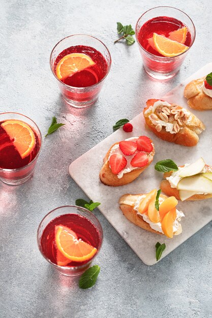 Fruit bruschetta with summer drink top view