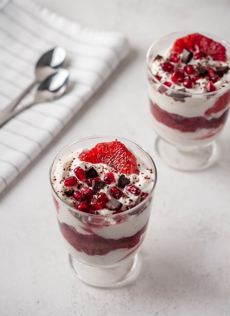 Fruit dessert with bloody oranges chia yogurt in a cup on top