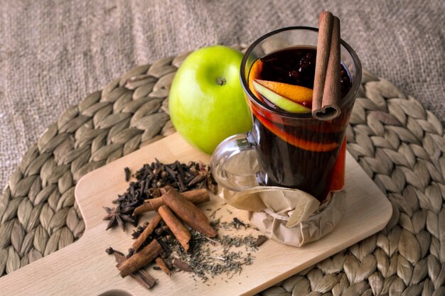 Fruit drink with cinnamon on a wooden board