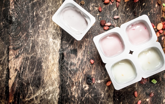 Fruit fresh yoghurt. On a wooden background.