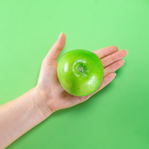 Fruit green apple ginger on colored background hands juice tasty