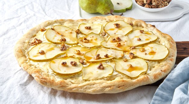 Fruit homemade pear pizza with cheese and honey, Rustic Italian savory food