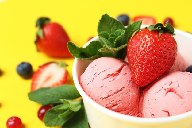 Fruit ice cream and ingredients on yellow background