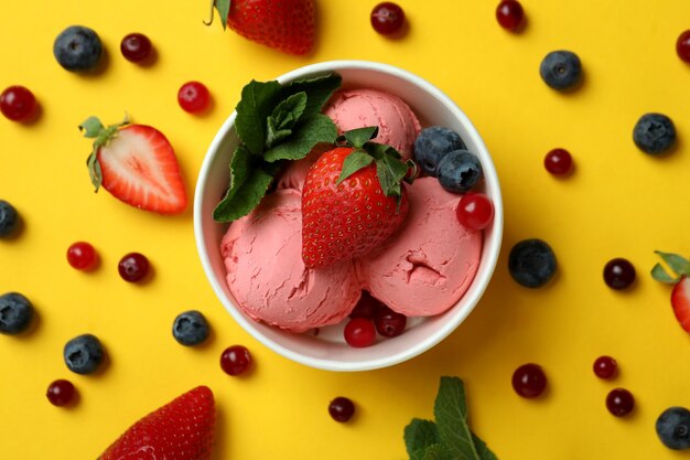 Fruit ice cream and ingredients on yellow