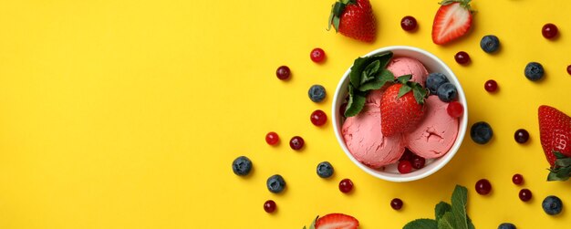 Fruit ice cream and ingredients on yellow
