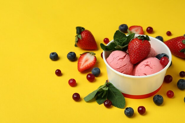 Fruit ice cream and ingredients on yellow