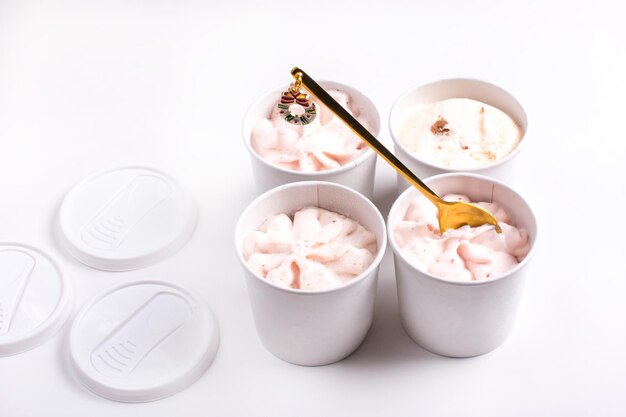 Fruit ice cream in a paper cup with a teaspoon