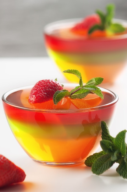 Fruit jelly with strawberries in bowls