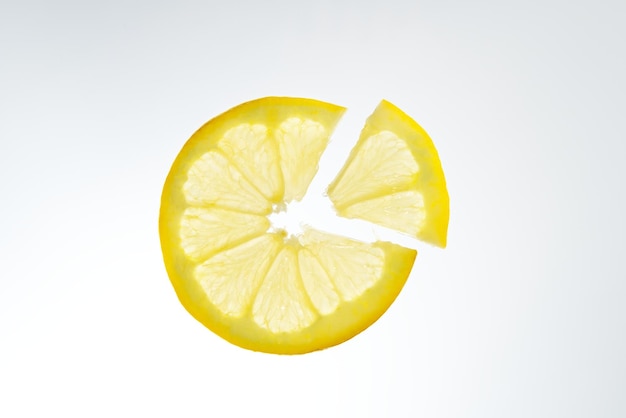 Fruit lemon sliced into slices on white background