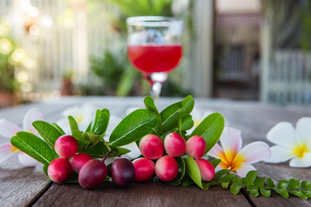 The fruit of the mango yawn lime ho which is squeezed into a bright red Thai herbal juice called carunda or karonda Carissa Carandas L a Thai herbal juice