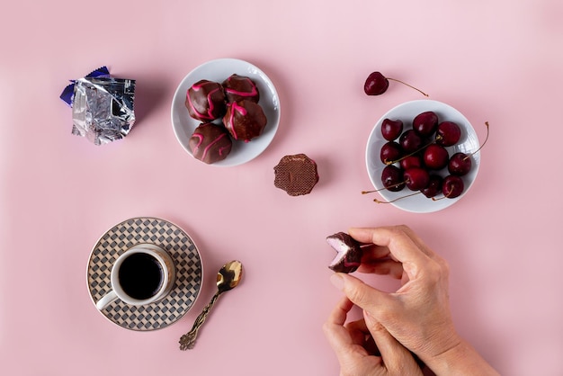 분홍색 배경에 선택적으로 초점을 맞춘 초콜릿 커피 체리 한 잔의 과일 마시멜로