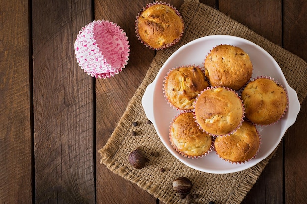 Fruit muffins with nutmeg and allspice on a wooden background