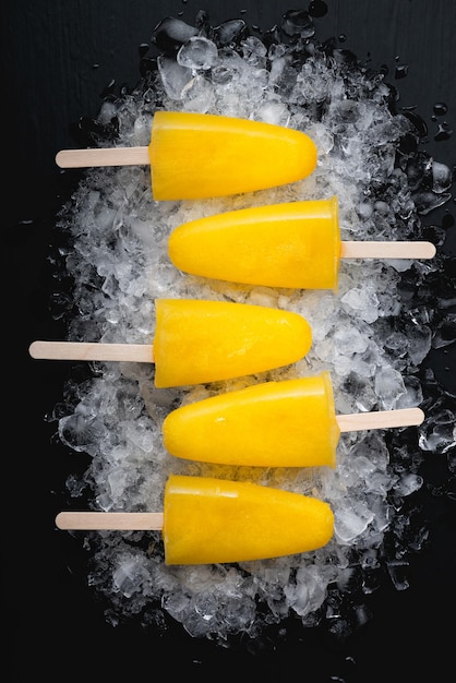fruit orange ice lolly on a black table