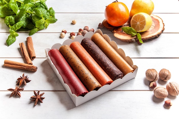 Fruit pastille of different flavors in a gift box and frash fruit nuts spices