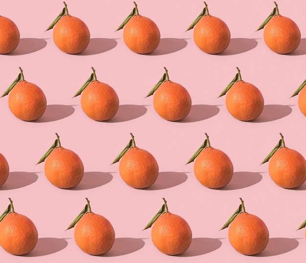 Fruit pattern of fresh tangerine on pink background