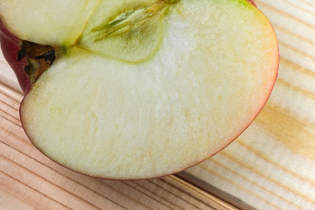 Fruit picture red ripe sweet cut apple on a light wooden background close-up macro photography