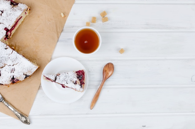 Fruit pie and tea on a wooden table