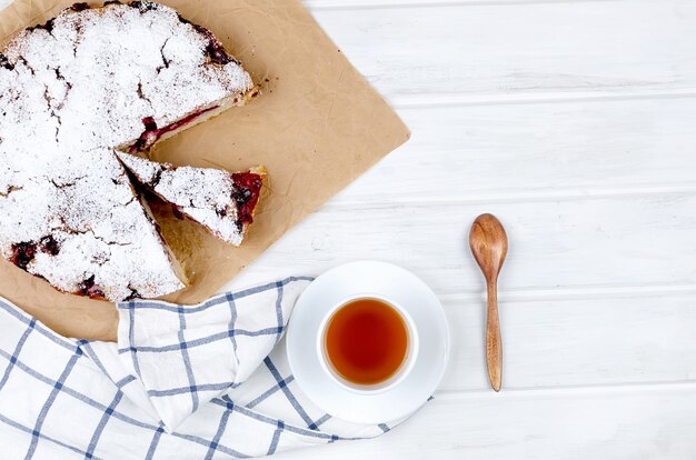 Fruit pie and tea on a wooden table