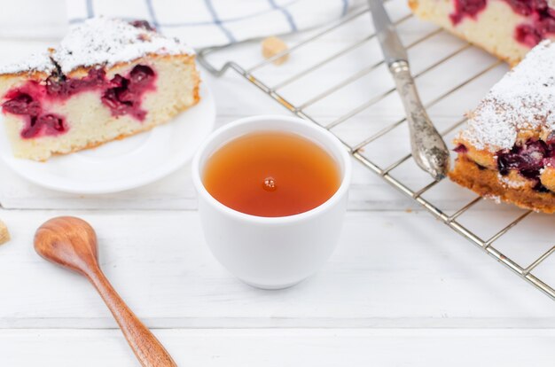 Fruit pie and tea on a wooden table