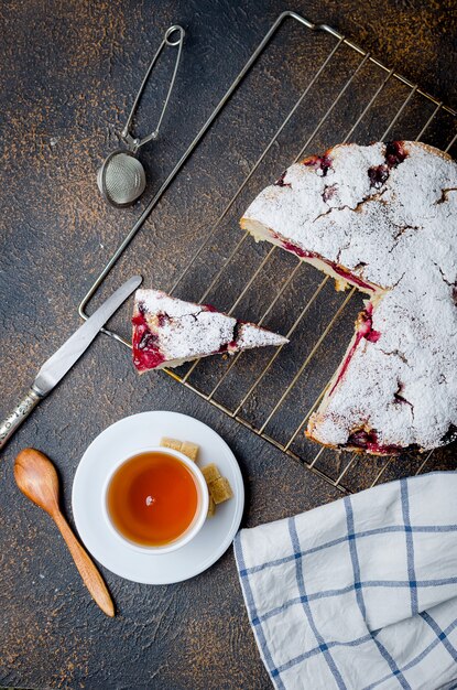 Fruit pie and tea on a wooden table