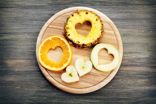 Fruit plakjes met gesneden in de vorm van een hart op houten achtergrond