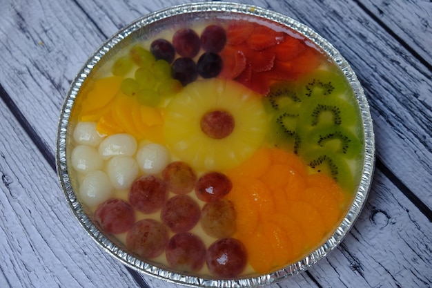 fruit pudding topped with grapes, lychee, kiwi, strawberry, orange, apricot. dessert. healthy food.