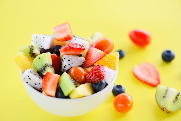 Fruit salad bowl fresh summer fruits healthy strawberries orange kiwi blueberries dragon fruit tropical 