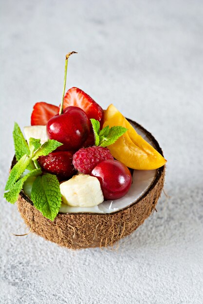 Fruit salad in a bowl of half coconut