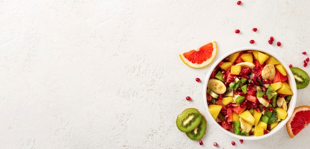 Fruit salad bowl on light surface