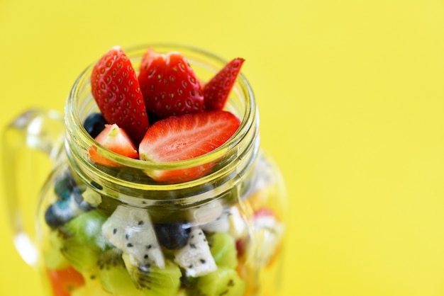 Fruit salad in a glass jar fresh summer fruits and vegetables