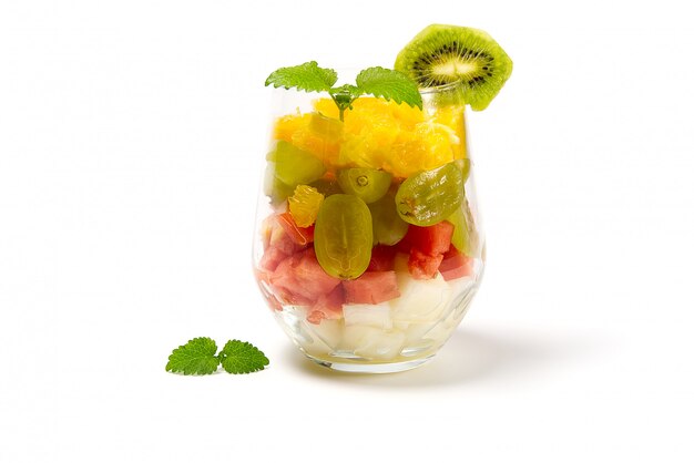 Fruit salad in the glass on white