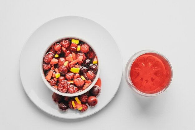 Fruit salad and juice on white. Healthy breakfast concept.